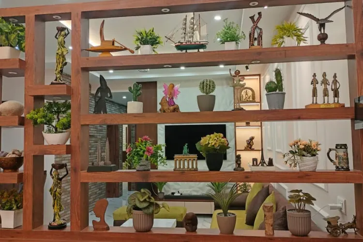 Curated Wooden Display with Greenery and Artistic Accents